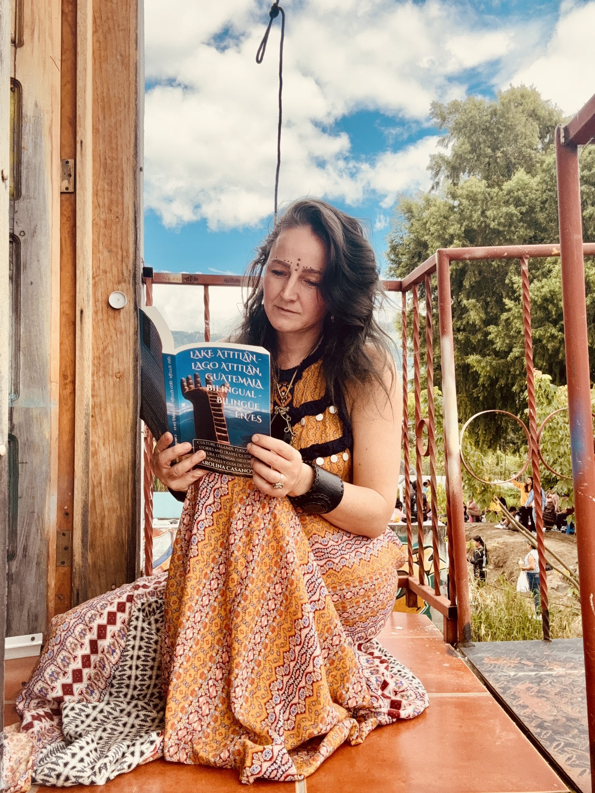 Carolina Casanova reading Lake Atitlán, Guatemala. This travel guide with history and mystery is available in English, Spanish and Bilingual to learn either language.