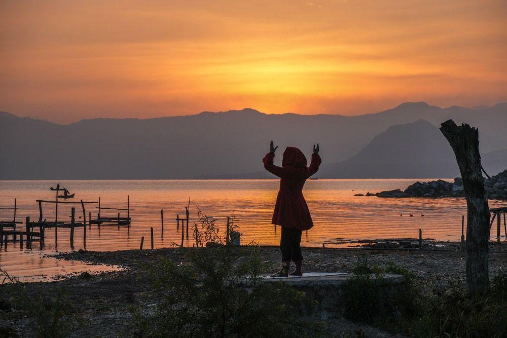 Carolina Casanova was photographed whilst doing her morning ritual in her little red riding hood jacket and Grinch socks at Lake Atitlán.