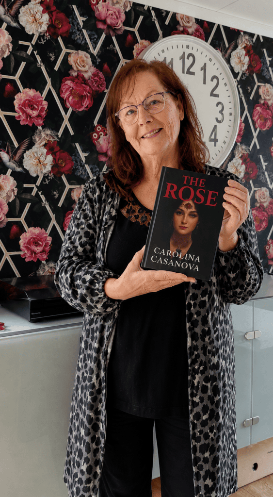 The mom of Carolina Casanova proudly holding her daughters book The Rose. 